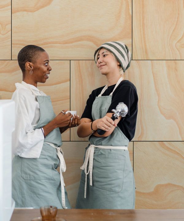 Ply Wood Wallpaper • Light Brown Wallpaper • Wood Grain Wallpaper with two co-workers conversing