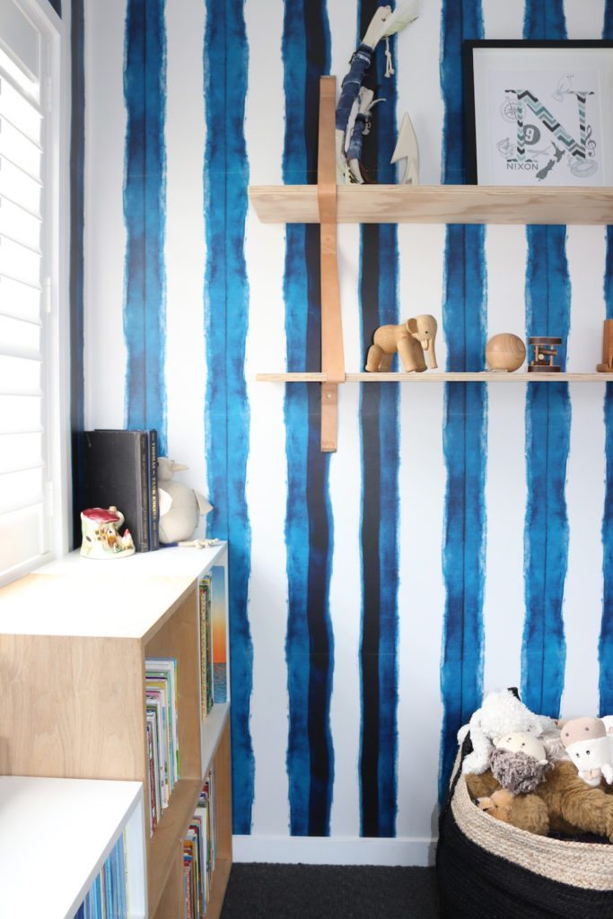 Boys bedroom with Shibori Stripe Wallpaper hung vertically shelving