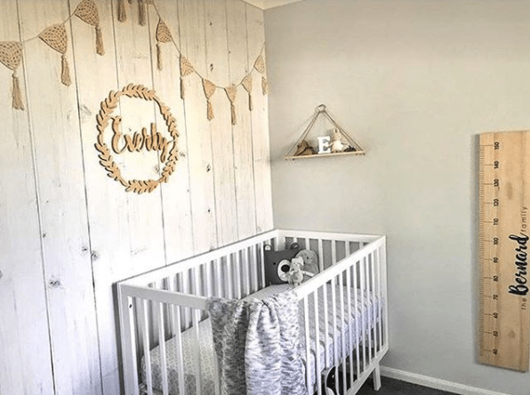 nursery with whitewashed timber wallpaper, the best seller for 2017, hung vertically with white crib wooden decorative wall art and a large ruler for measuring growing kids