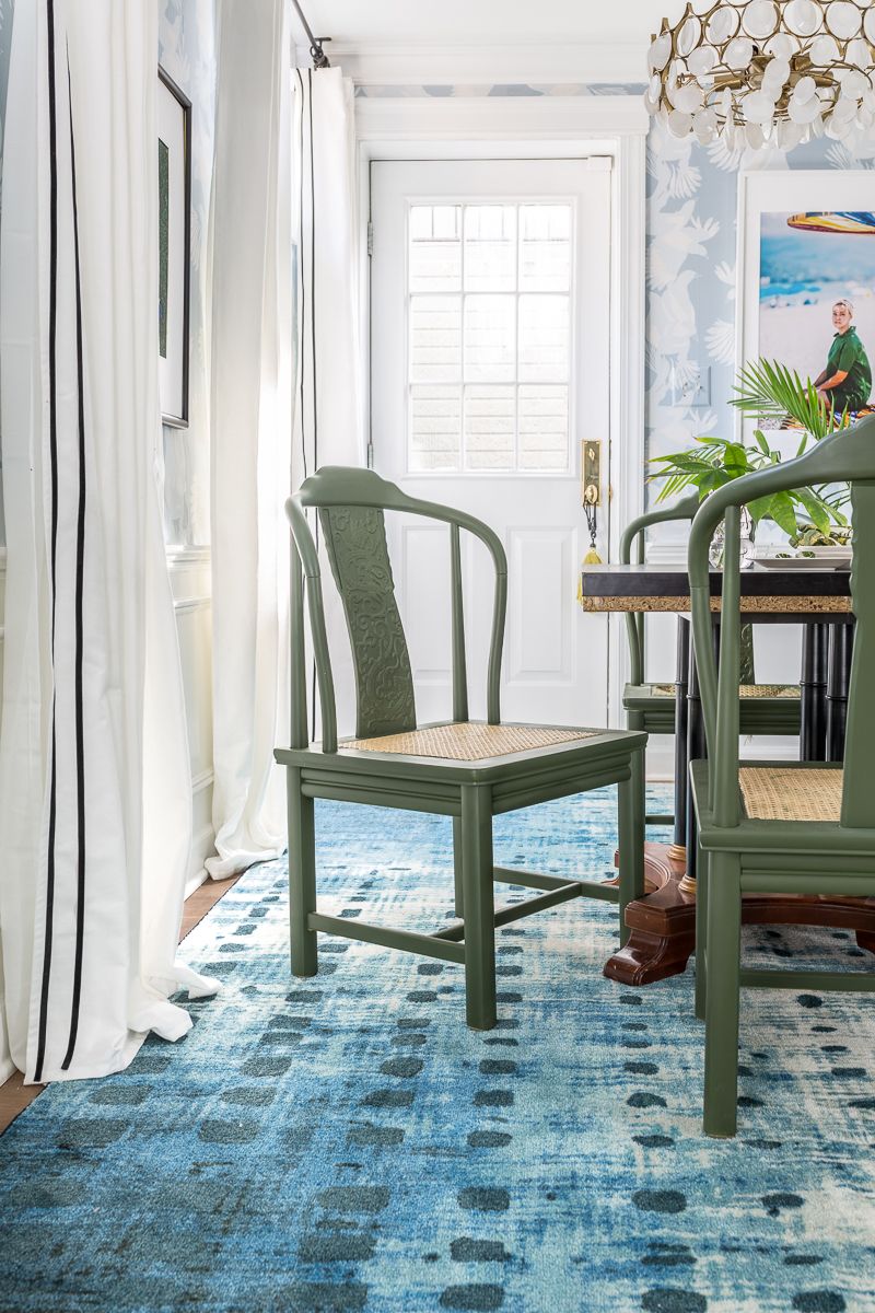 Jewel Marlowe Basement Makeover • A blue carpet with a kitchen table with green chairs and light blue magpie wallpaper from Milton & King on the wall