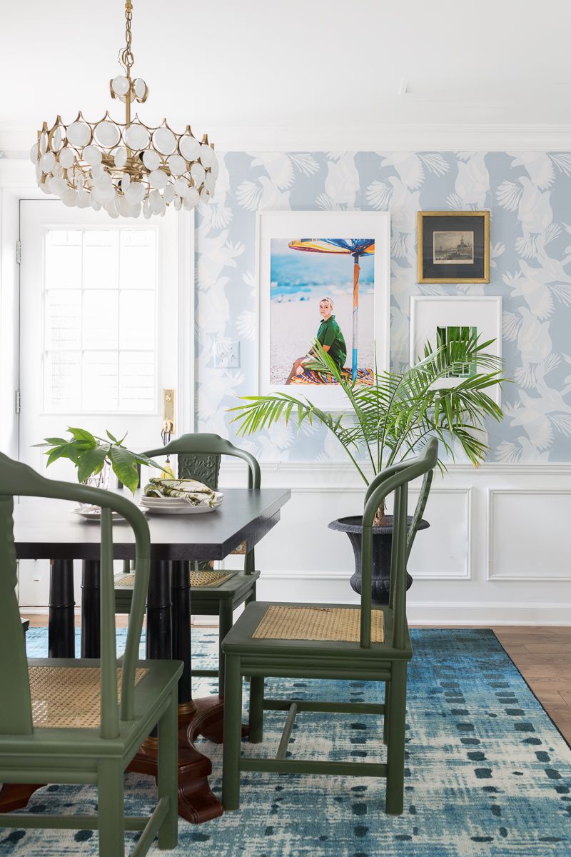 Jewel Marlowe Basement Makeover • A blue carpet with a kitchen table with green chairs and light blue magpie wallpaper from Milton & King on the wall