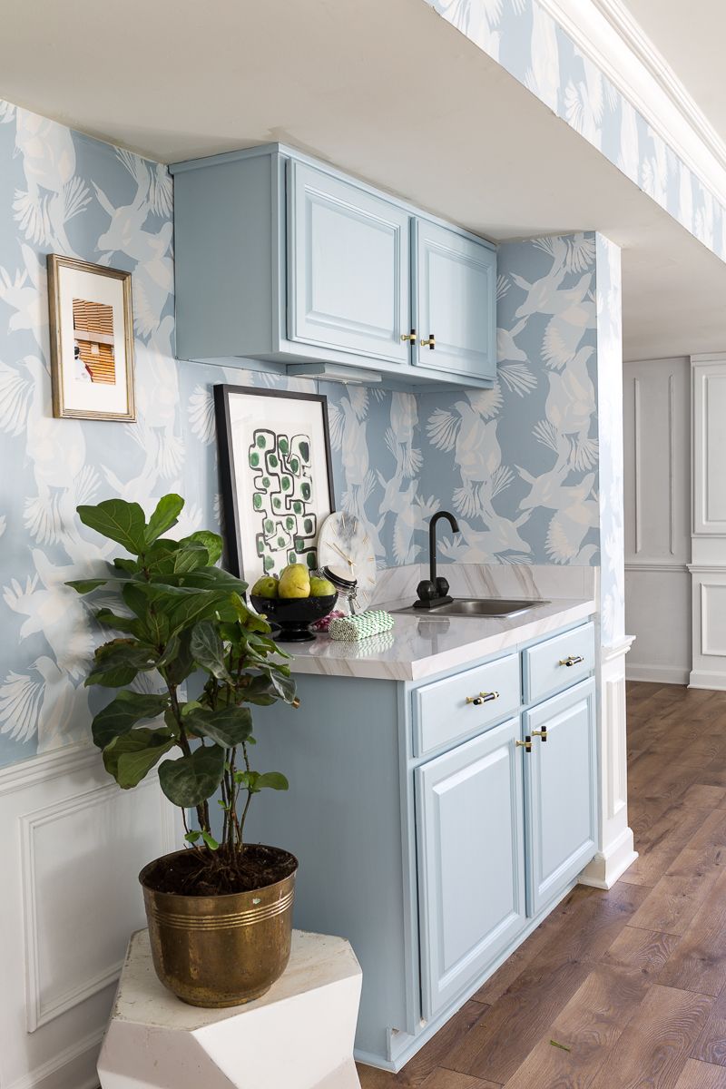 Jewel Marlowe Basement Makeover • Kitchen Cabinets have been painted a light blue to match the light blue magpie wallpaper