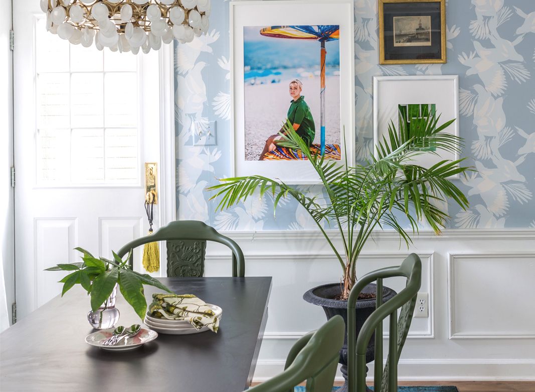 Jewel Marlowe Basement Makeover • A blue carpet with a kitchen table with green chairs and light blue magpie wallpaper from Milton & King on the wall