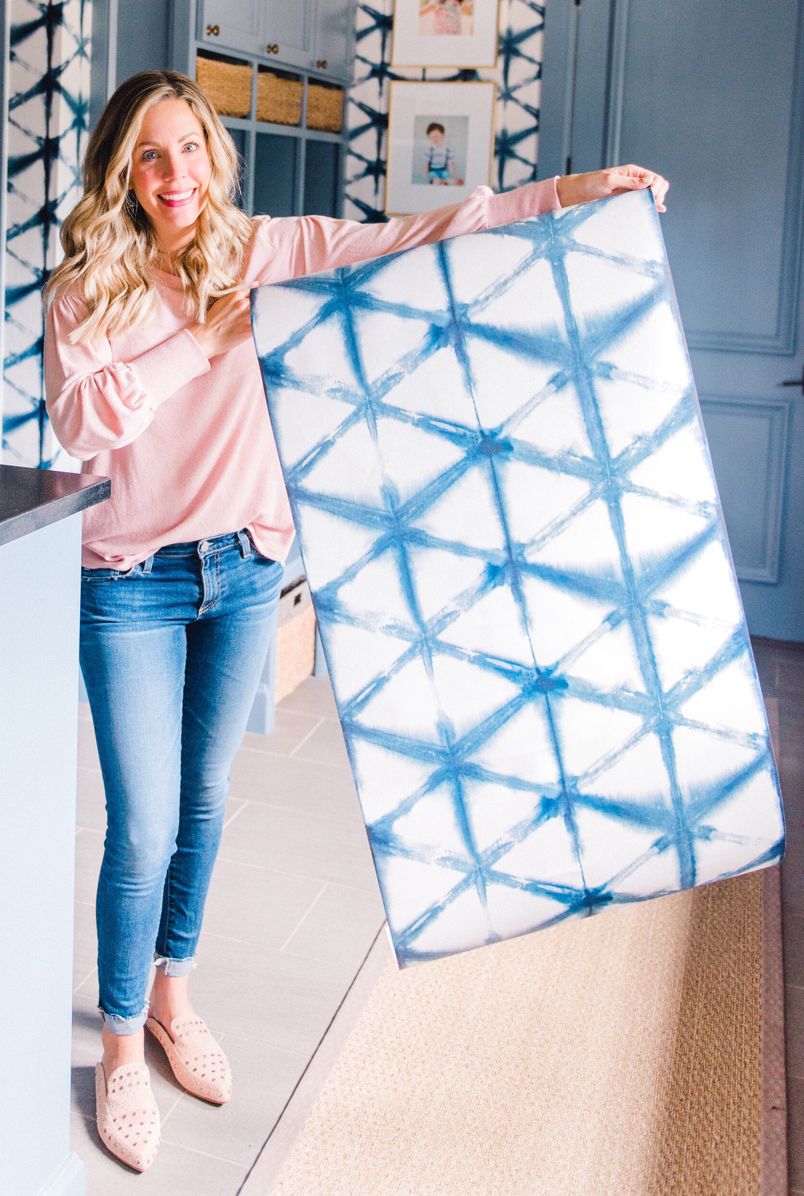 Ashley Massegee from the Curls & Cashmere Blog is holding her Shibori Star Wallpaper from Milton & King. This is a blog with important information for wallpaper first-timers